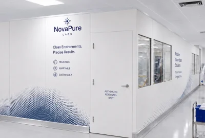 Sterile lab hallway with NovaPure Labs branding and the words 'Clean Environments. Precise Results.' on white panels